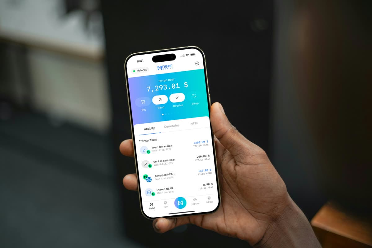 NEAR Mobile wallet open on a phone held in one hand